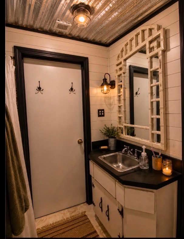 Remodeled bathroom with dark countertop vanity