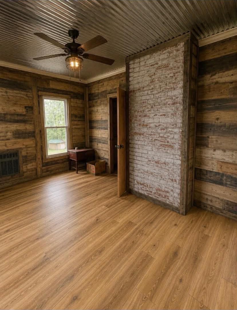 Remodeled bedroom with reclaimed wood accent wall and corrugated ceiling