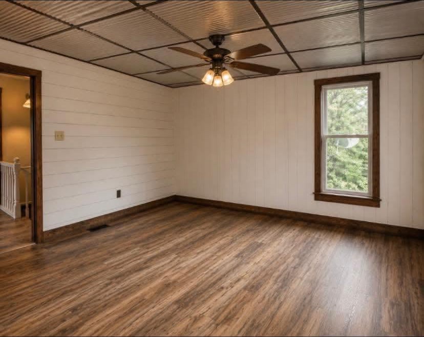 Remodeled bedroom with corrugated ceiling and shiplap walls
