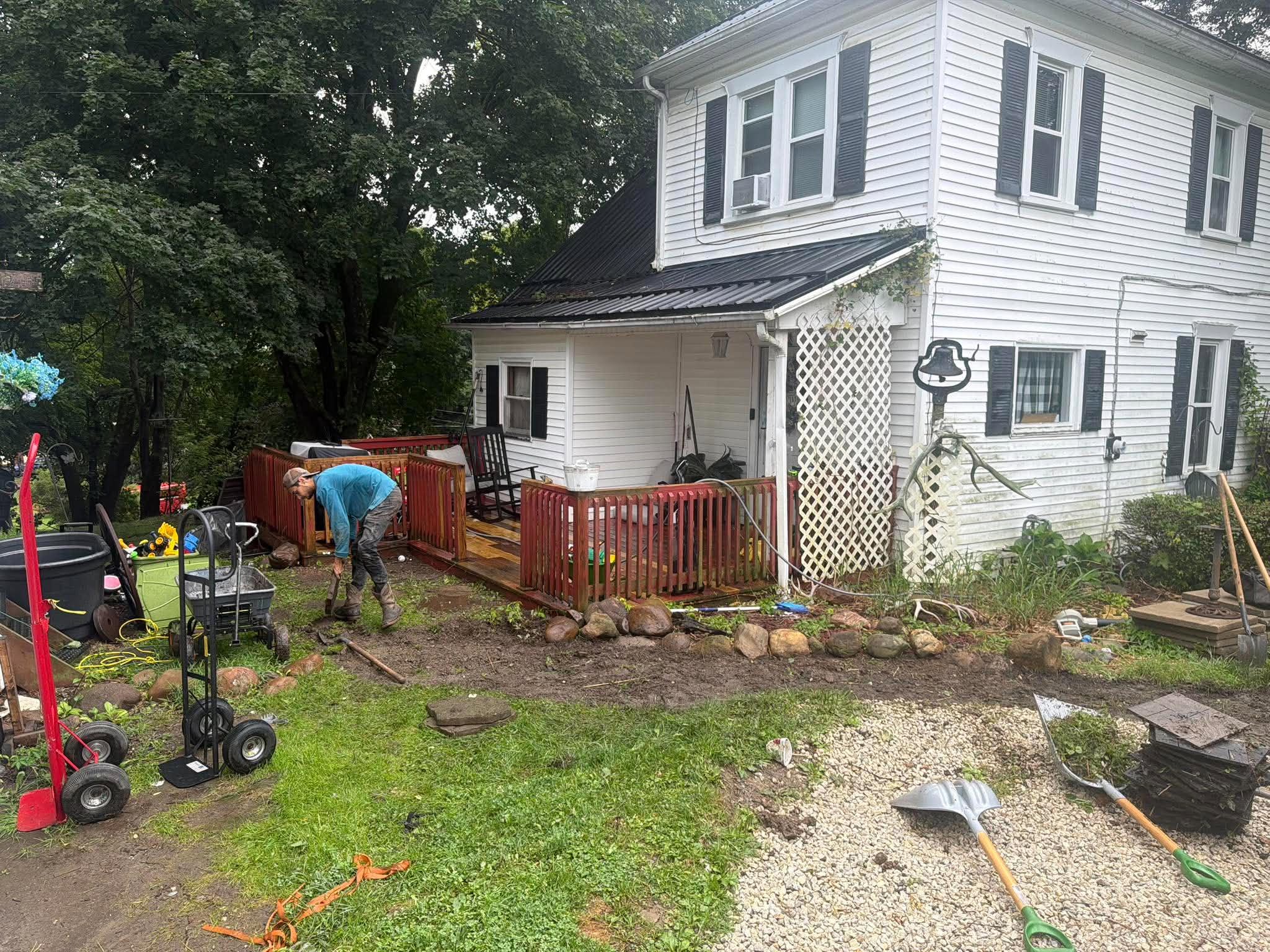 Stone border being placed around a garden bed